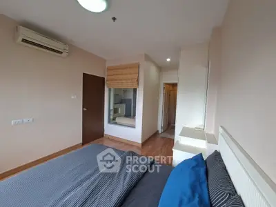 Spacious bedroom with modern decor and air conditioning in a stylish apartment.