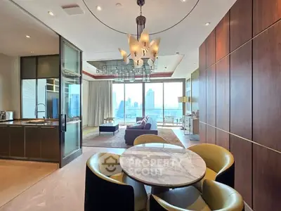 Luxurious open-plan living room with stunning city view and modern chandelier
