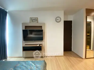 Modern bedroom with wall-mounted TV and stylish decor