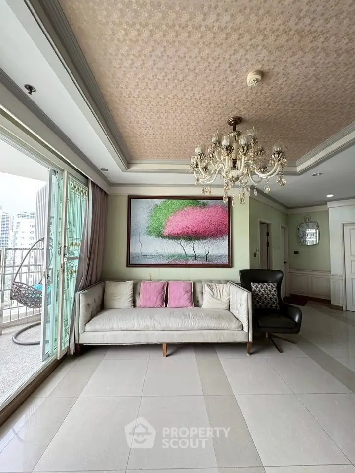 Luxurious living room with elegant chandelier and balcony view in upscale apartment.