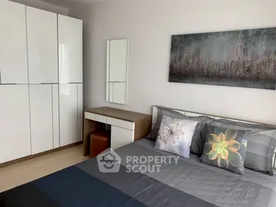 Modern bedroom with sleek wardrobe and stylish decor in a contemporary apartment.