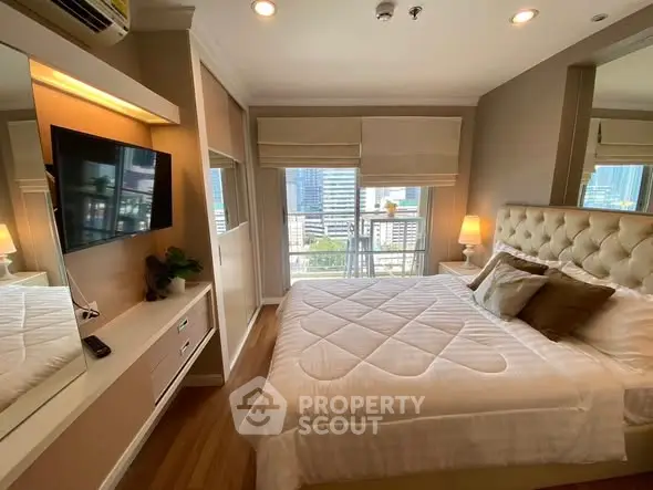 Luxurious bedroom with city view, elegant decor, and modern amenities.