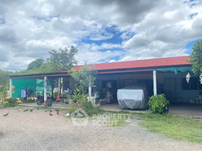 Charming rural property with spacious outdoor area and covered parking, ideal for countryside living.