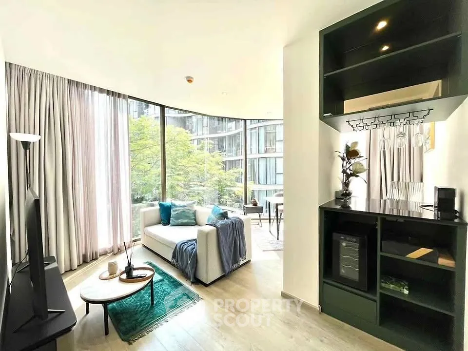 Modern living room with large windows and stylish decor in a contemporary apartment.