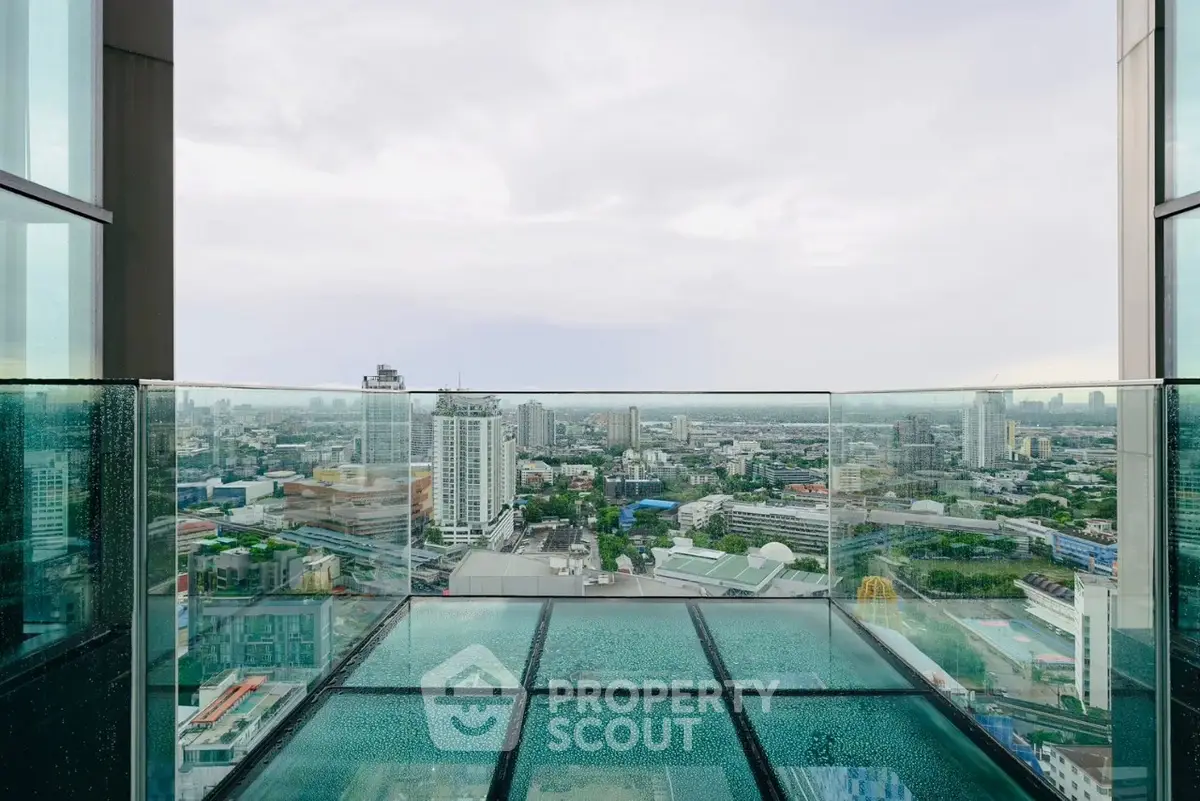 Stunning cityscape view from a high-rise glass balcony, perfect for urban living.