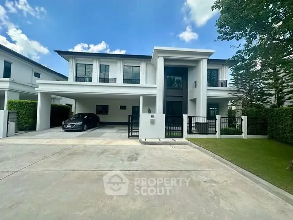 Stunning modern two-story house with sleek design and spacious driveway in a serene neighborhood.