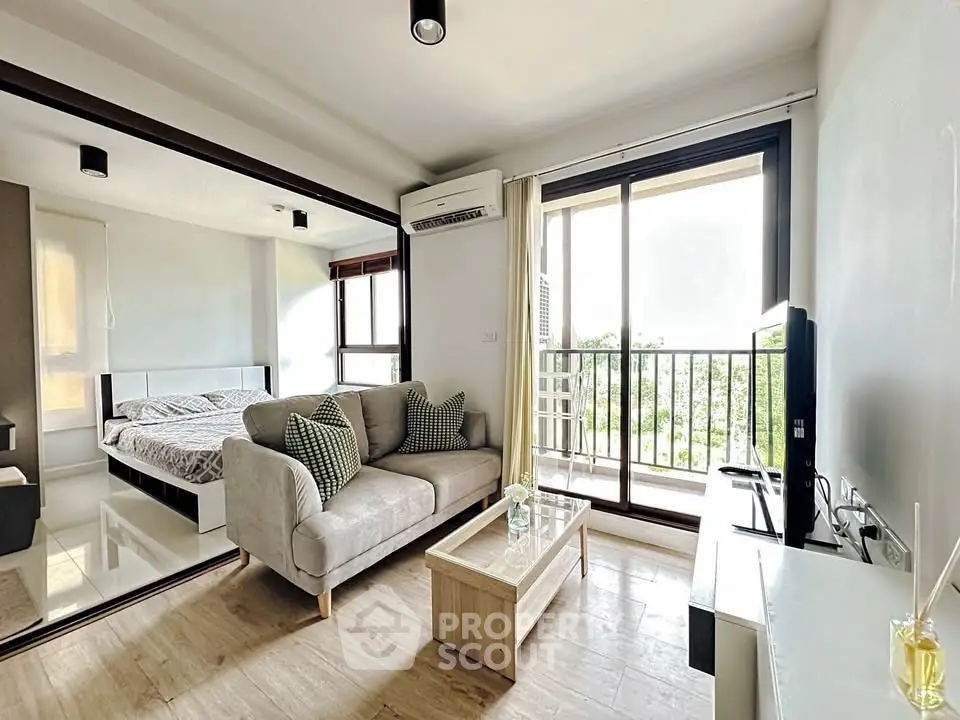 Modern open-plan living room with balcony view and cozy bedroom