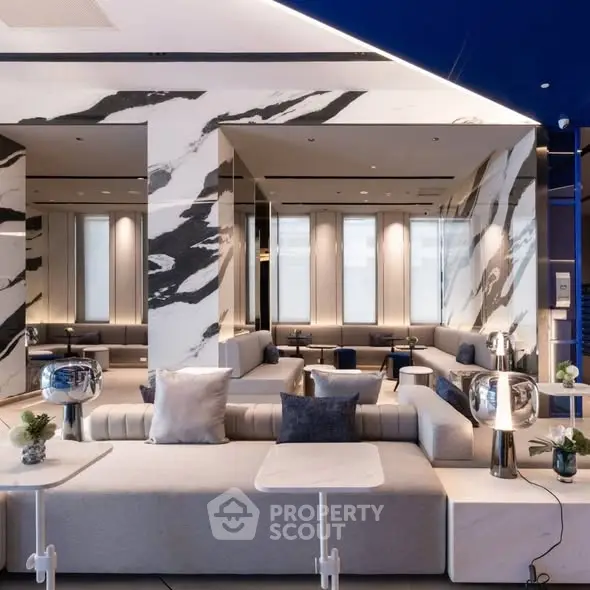 Luxurious modern living room with elegant marble walls and stylish seating area.