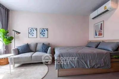 Cozy bedroom with modern decor and comfortable seating area