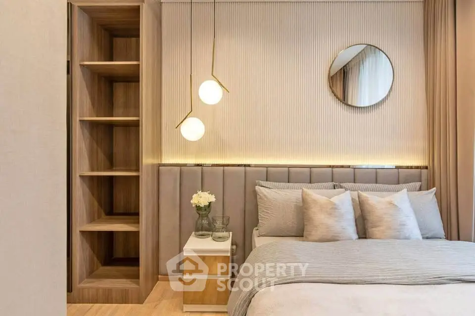Elegant bedroom with modern decor, featuring a cozy bed, stylish lighting, and built-in shelving.