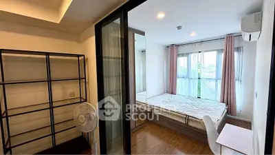 Modern bedroom with large windows and sleek furniture in a stylish apartment.