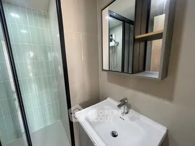 Modern bathroom with sleek sink and glass shower enclosure