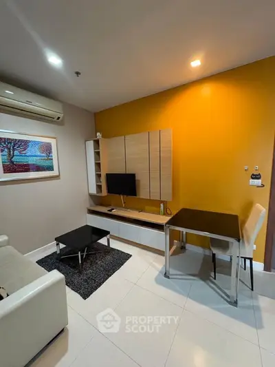 Modern living room with vibrant yellow accent wall and sleek furniture