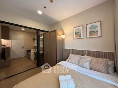 Cozy bedroom with modern decor and adjacent living area in stylish apartment