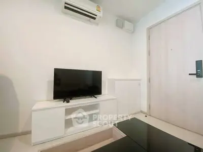 Modern living room with sleek TV setup and air conditioning, perfect for cozy entertainment.