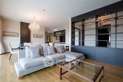 Luxurious modern living room with elegant chandelier and spacious seating area.