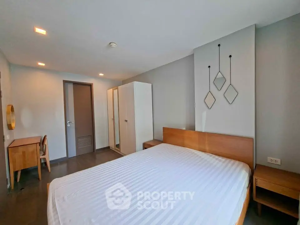Spacious modern bedroom with minimalist decor and ample natural light