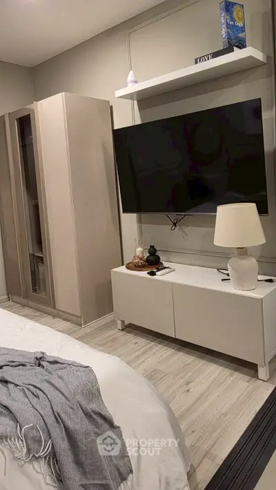 Modern bedroom with sleek TV setup and stylish decor