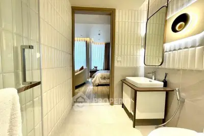 Modern bathroom with stylish lighting and view into elegant bedroom