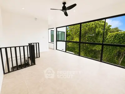 Spacious modern living room with large windows and scenic view