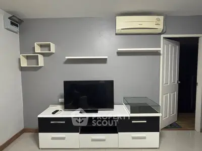 Modern living room with sleek TV stand and wall-mounted shelves