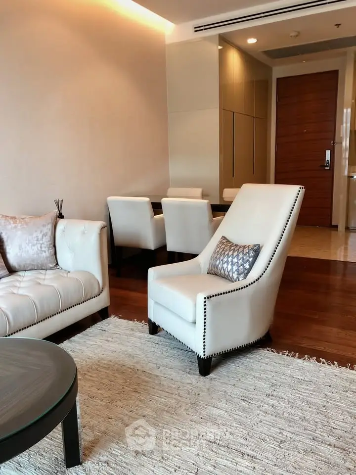 Elegant living room with plush seating and modern decor in a luxurious apartment.