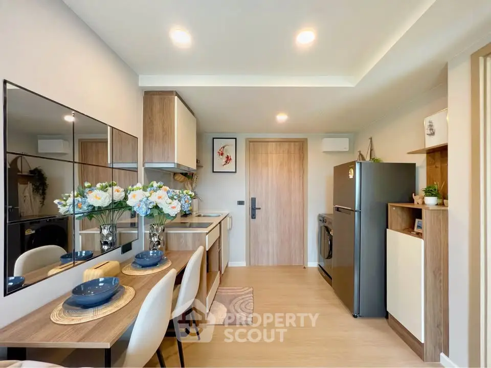 Modern kitchen with dining area, featuring sleek appliances and stylish decor.