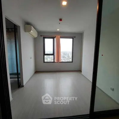 Spacious empty room with large windows offering city view, perfect for customization.