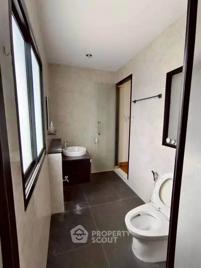 Modern bathroom with sleek fixtures and large windows for natural light.