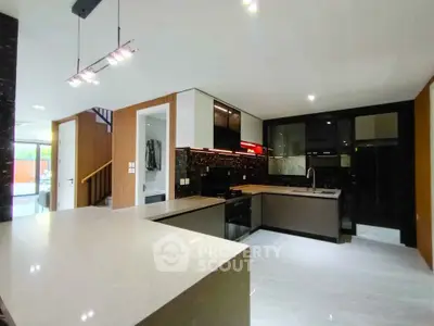 Modern kitchen with sleek design and open layout, featuring stylish cabinetry and high-end appliances.