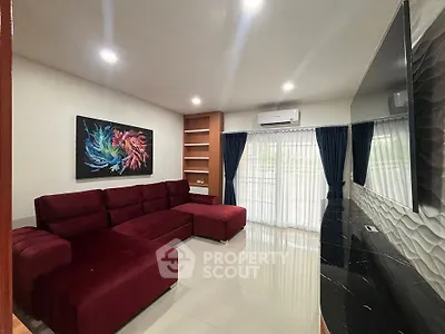 Spacious living room with modern red sectional sofa and elegant decor