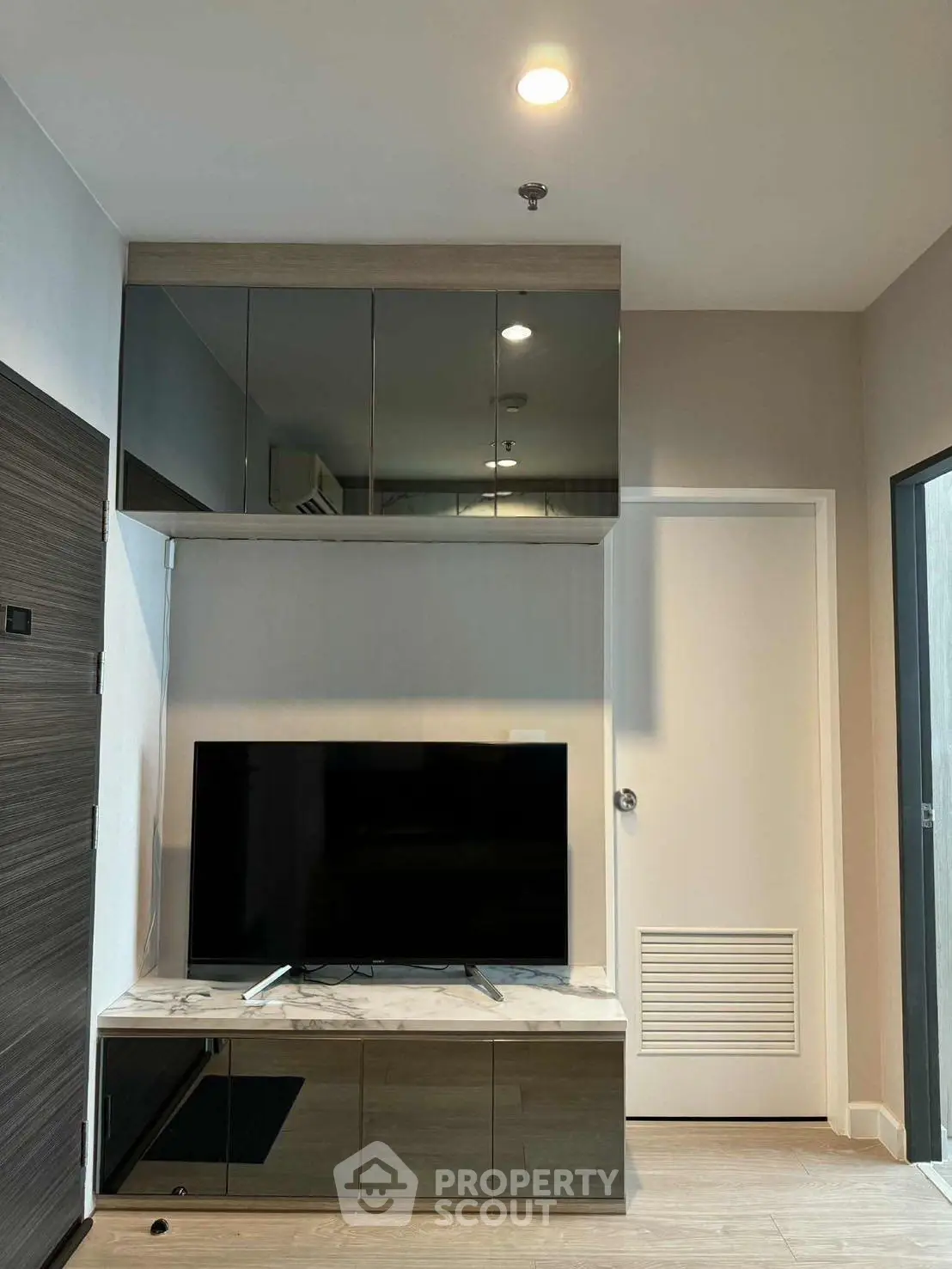 Modern living room with sleek TV setup and stylish cabinetry