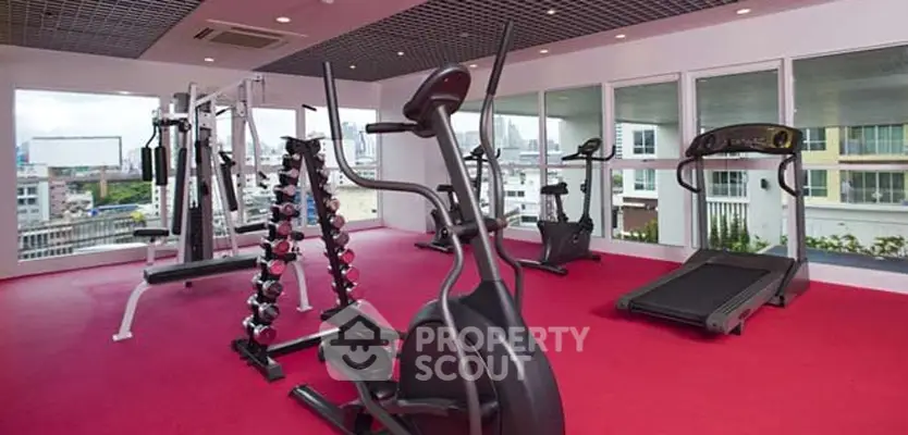 Modern gym with city view and state-of-the-art equipment