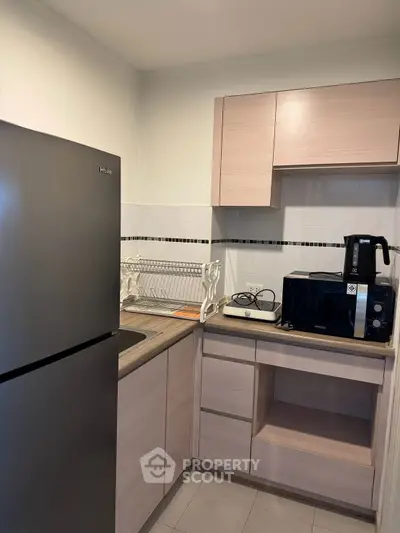 Modern kitchen with sleek appliances and ample storage in a compact layout.