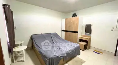 Cozy bedroom with modern wardrobe and vanity set, perfect for relaxation.