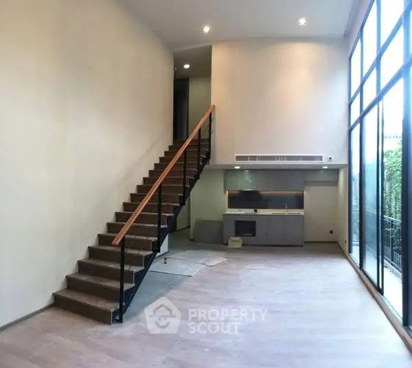 Spacious modern living room with high ceilings and large windows