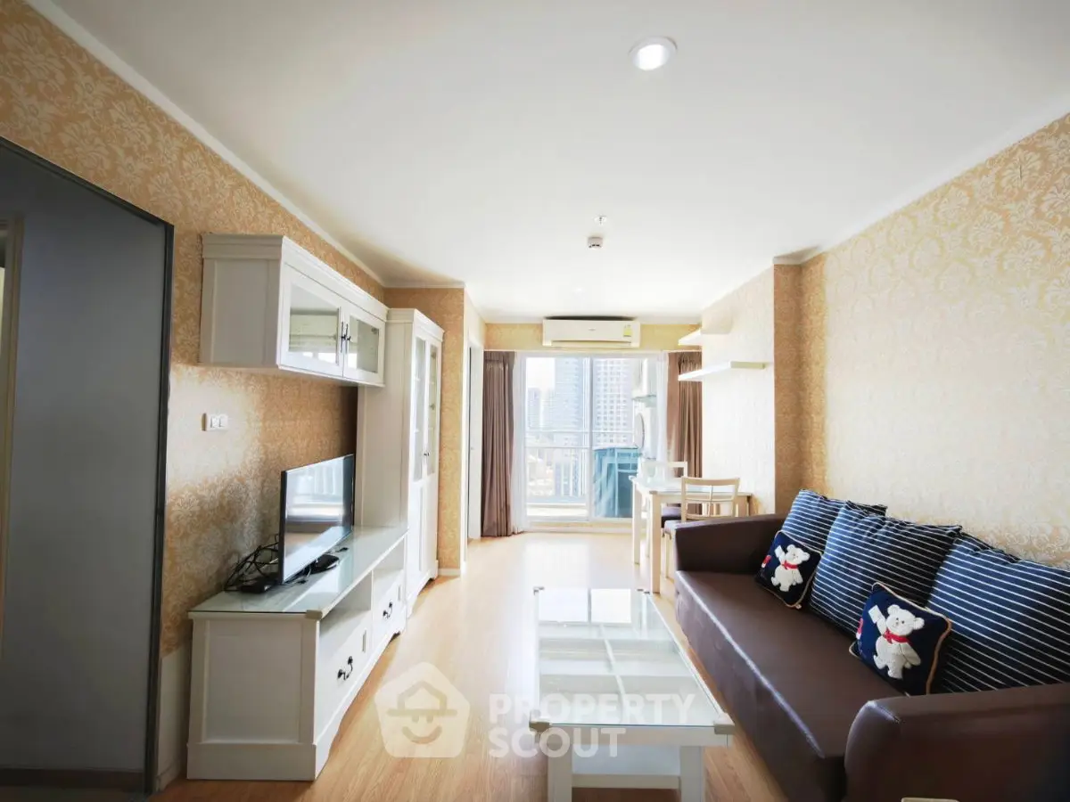 Spacious living room with elegant decor and city view, featuring modern furniture and ample natural light.