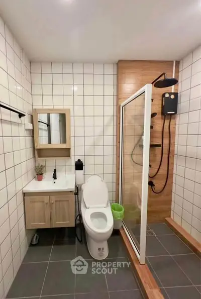 Modern bathroom with sleek shower and stylish vanity in contemporary home.