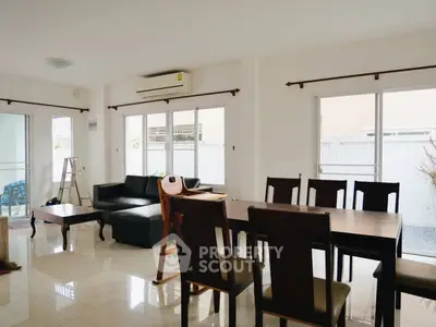 Spacious living room with modern furniture and large windows for natural light
