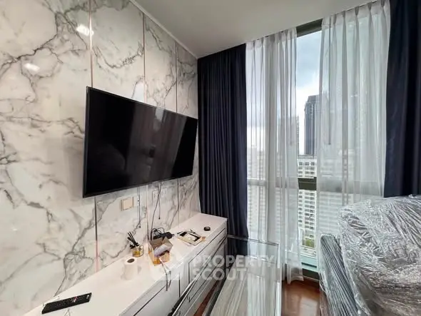 Modern living room with marble accent wall and city view, featuring a sleek TV setup.