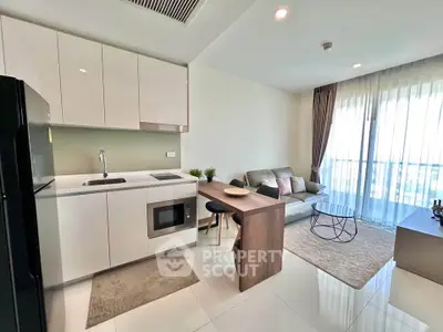 Modern open-plan kitchen and living room with sleek design and natural light.