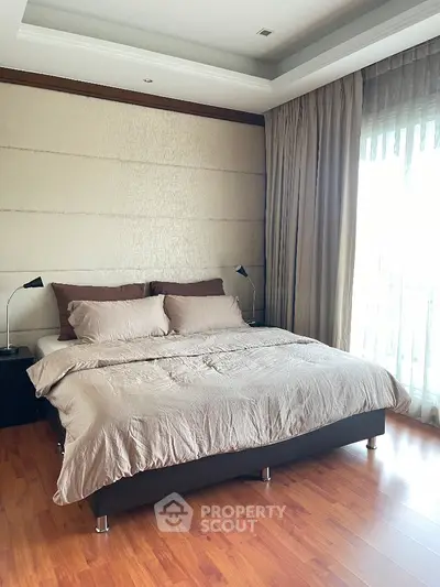Luxurious bedroom with elegant decor and large windows for natural light