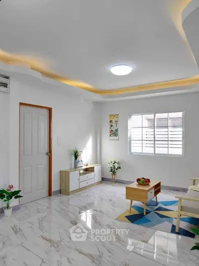 Modern living room with marble flooring and stylish ceiling lights.