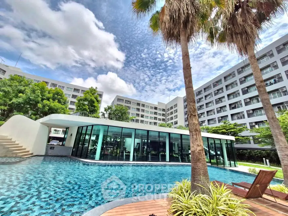 Luxurious apartment complex with stunning pool and modern architecture, perfect for upscale living.