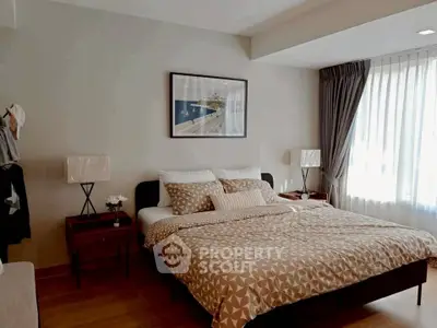 Spacious bedroom with modern decor and natural light