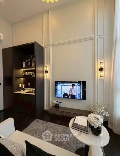 Luxurious living room with modern decor, wall-mounted TV, and elegant lighting.
