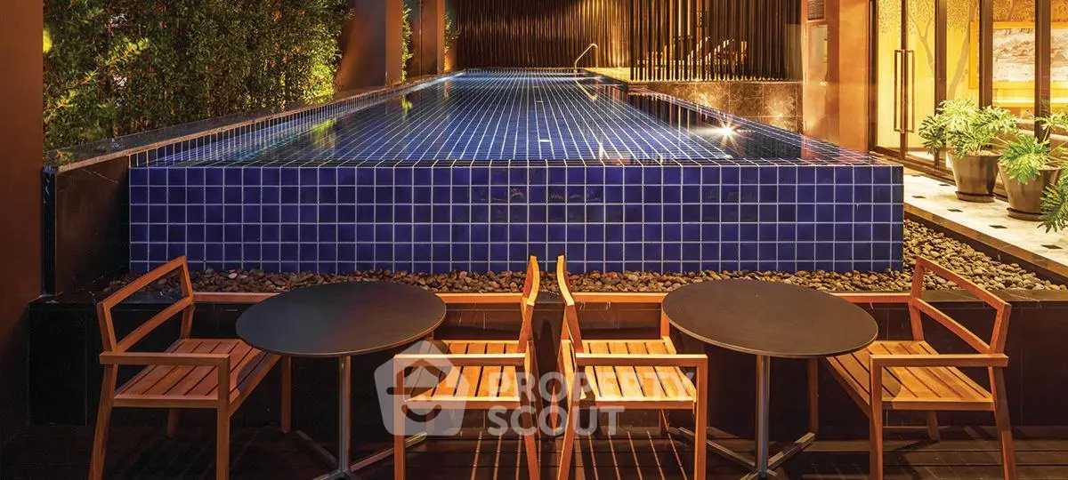 Luxurious rooftop pool with elegant seating area and ambient lighting