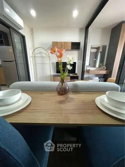 Modern open-plan living and dining area with stylish decor and natural light.