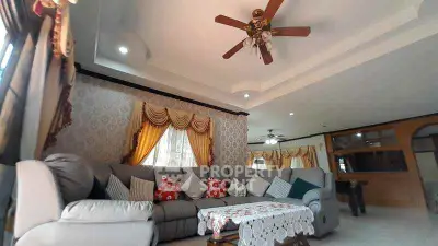 Spacious living room with elegant decor and ceiling fan