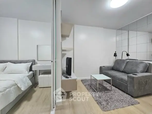 Modern studio apartment with cozy living area and stylish bedroom